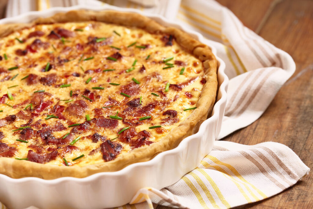 Quiche recipe in a white pie pan.