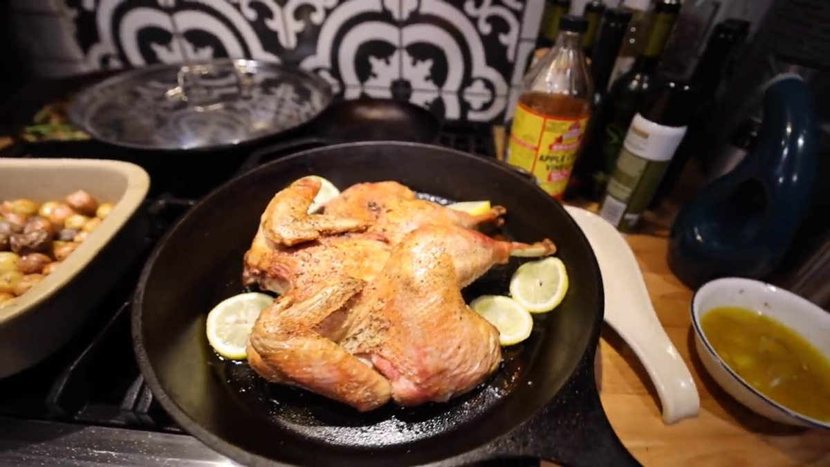 Spatchcock chicken finished in a cast iron pan.