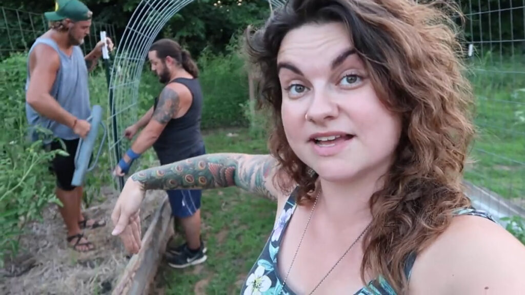 A woman describing how to build a vertical arched trellis.