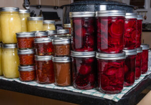 Various jars of stacked canned foods.