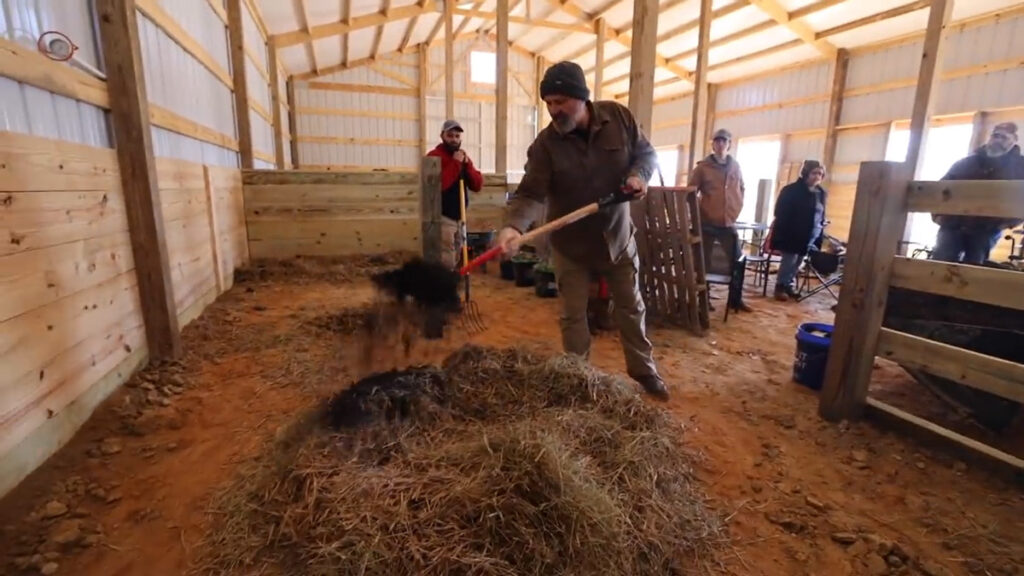 A man adding compost to a compost pile.