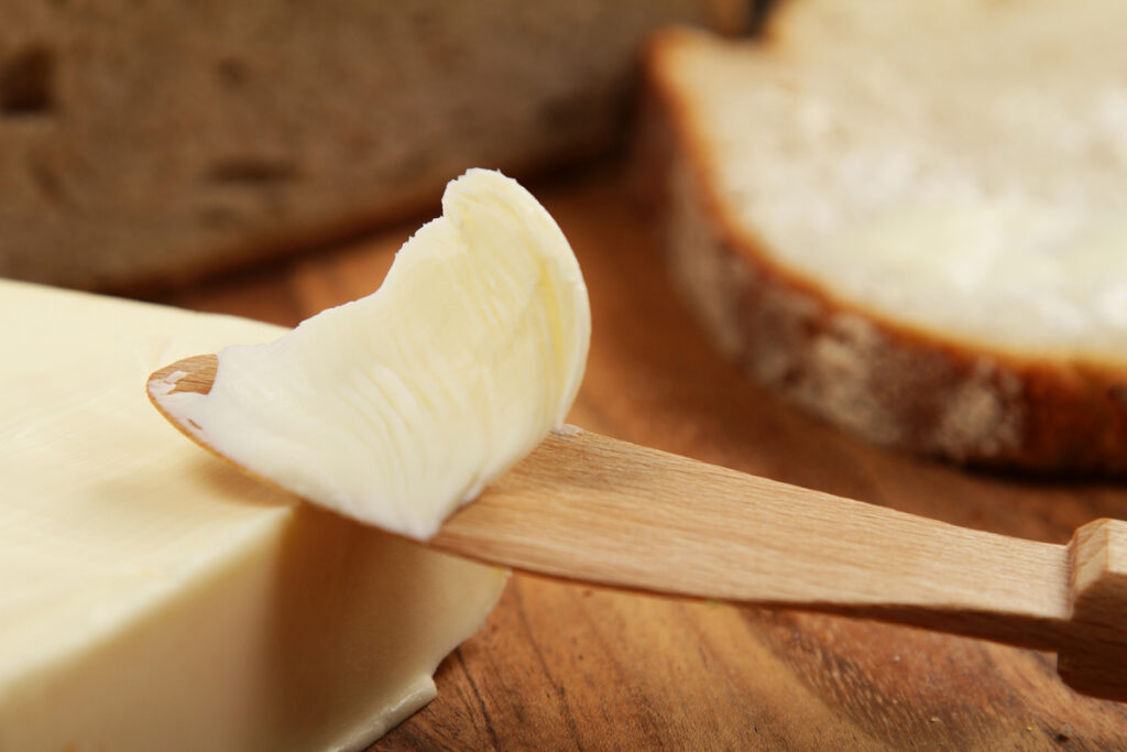 Homemade butter on a wooden knife.