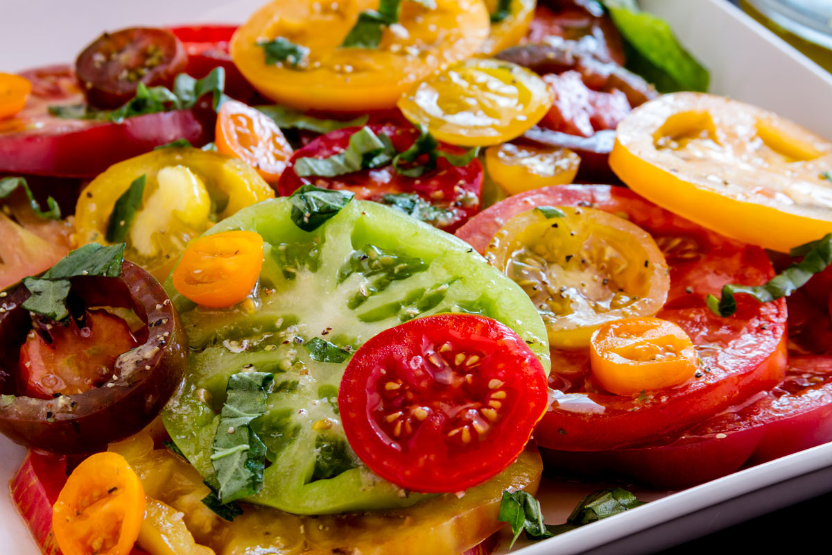 Sliced heirloom tomatoes with salt and pepper and oil.