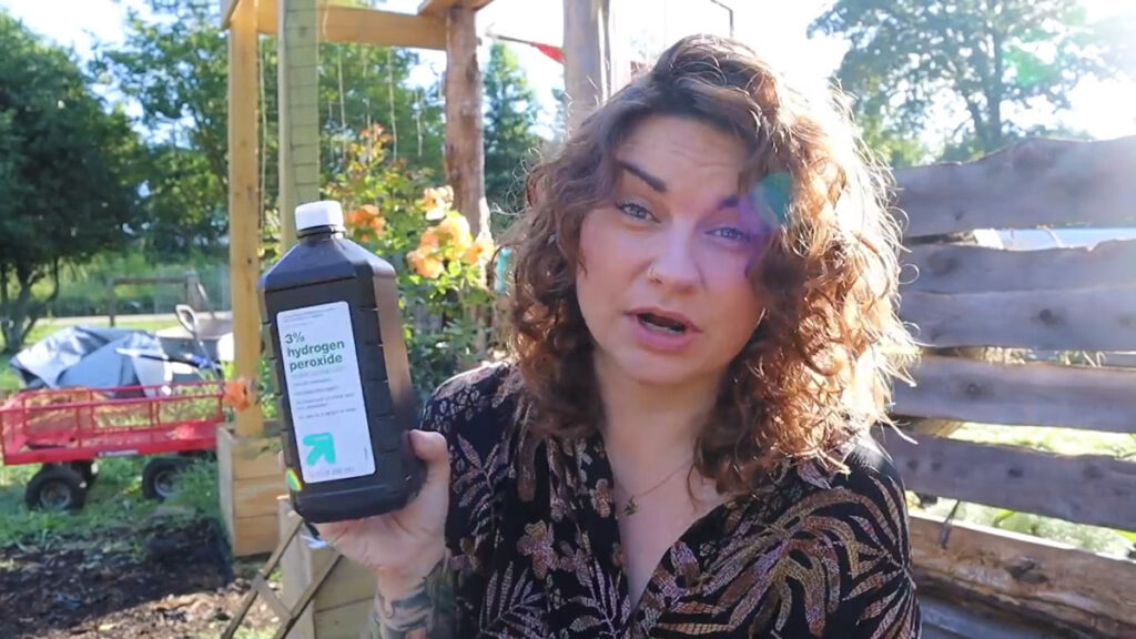 A woman holding up a bottle of hydrogen peroxide.