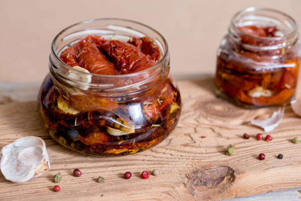 Sun dried tomatoes in oil in a glass jar.