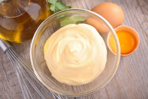 Aioli in a clear glass bowl.