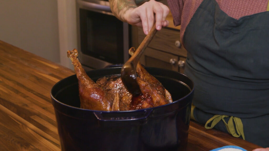 Pouring glaze over a turkey.