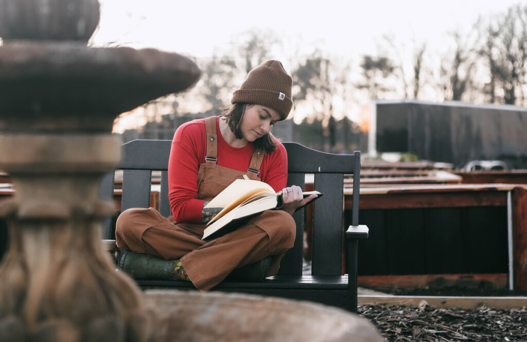 A woman sitting on a chair journaling.