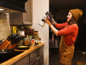 A woman taking a photo of something she cooked.