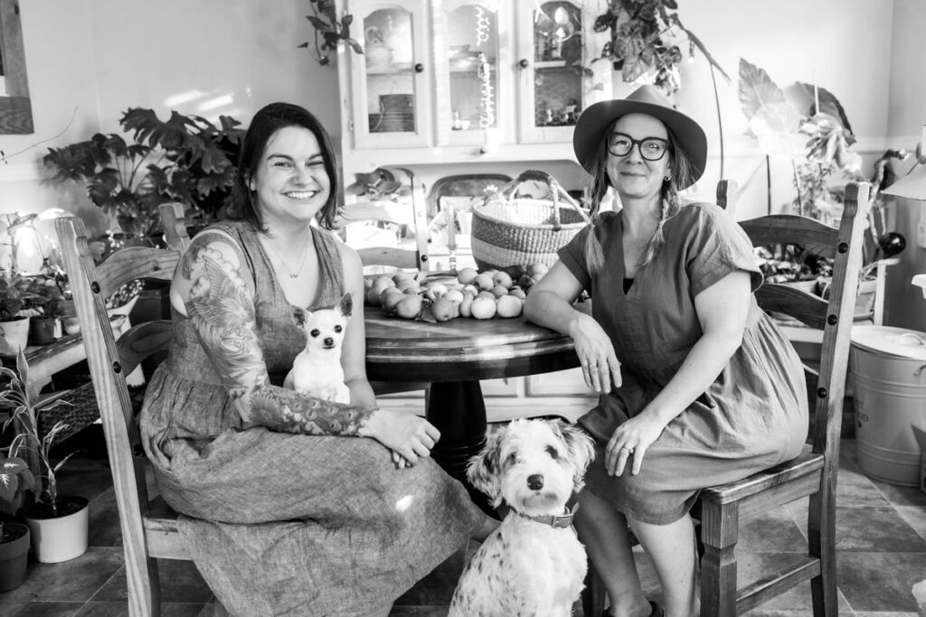 Black and white photo of two women sitting at a table.